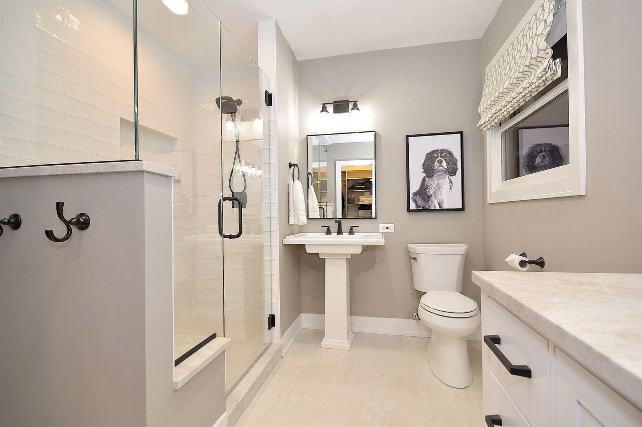 Bathroom design | Bathroom renovation view from the doorway showing shower enclosure, pedestal sink and toilet.