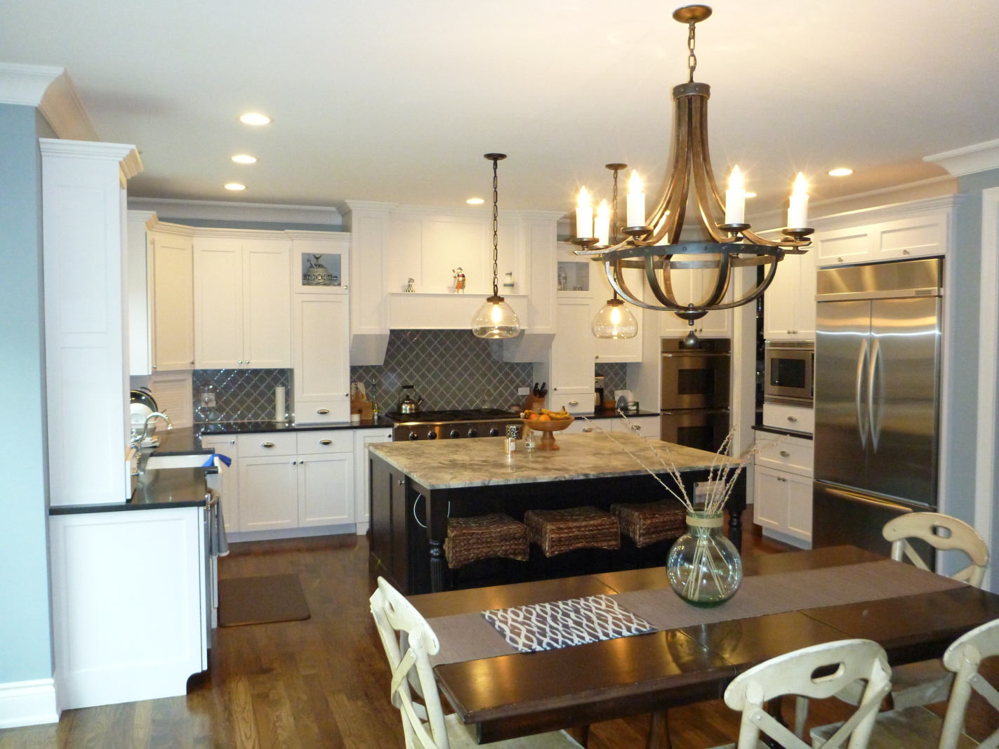 Custom home kitchen design - view of island, range and refrigerator - Platinum Builders