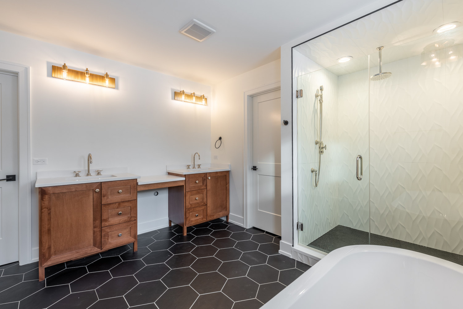 Custom Home master bathroom design - view of double vanity, shower with glass doors and tiled shower walls - by Platinum Builders