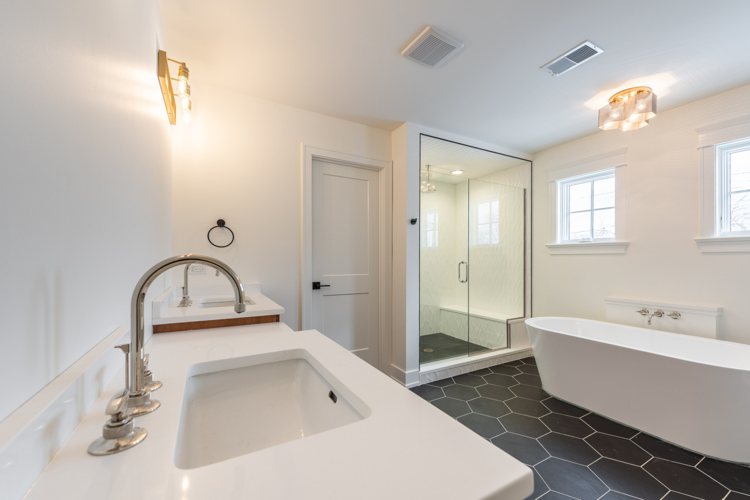 Custom home bathroom design - master bathroom view from angle to capture full view of vanity, bathtub and shower - by Platinum Builders