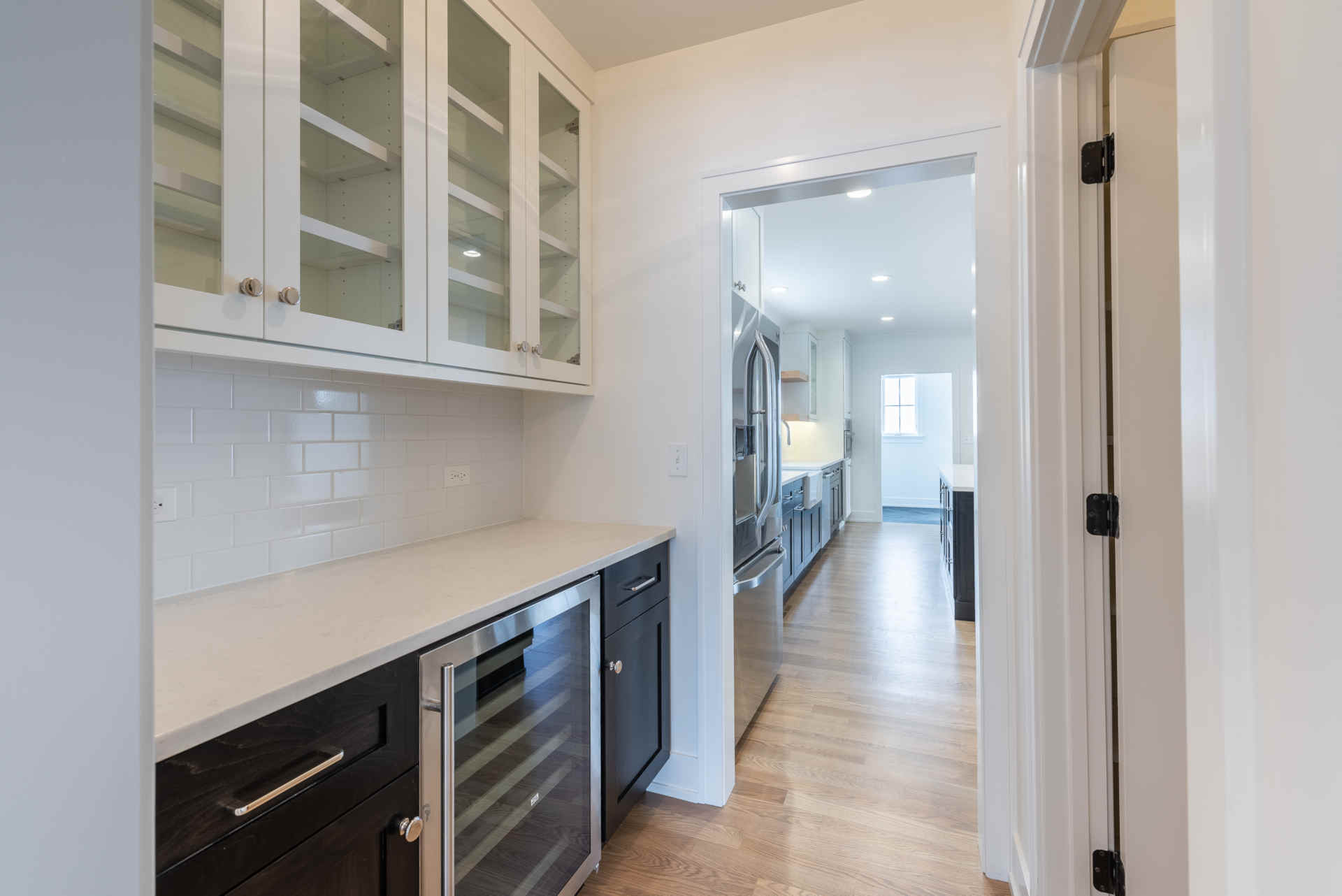 New Construction home in Downers Grove - wine cooler with upper cabinet with glass pane doors.