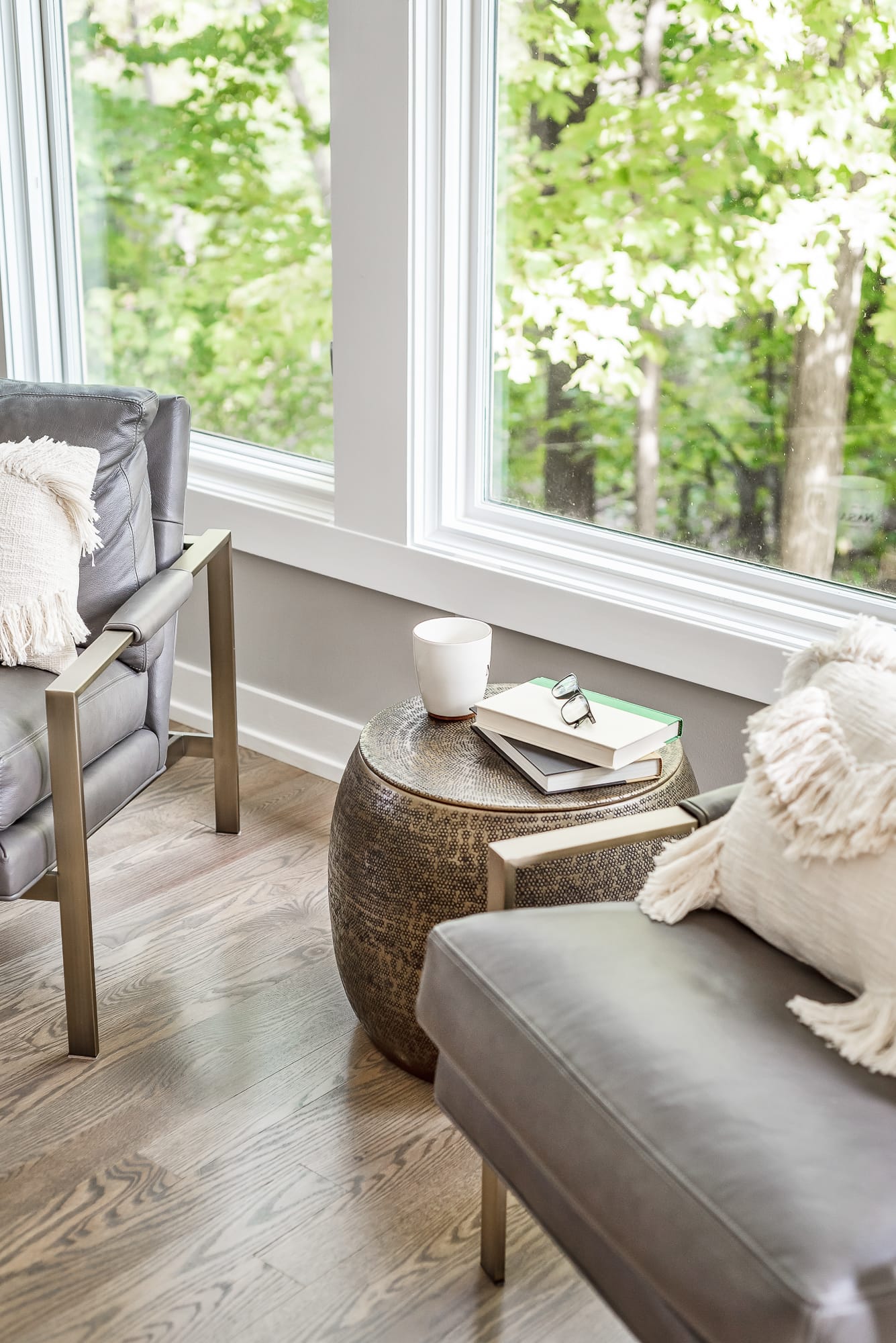 Living room remodel in Downers Grove - image of sitting chairs and small table by large set of windows.