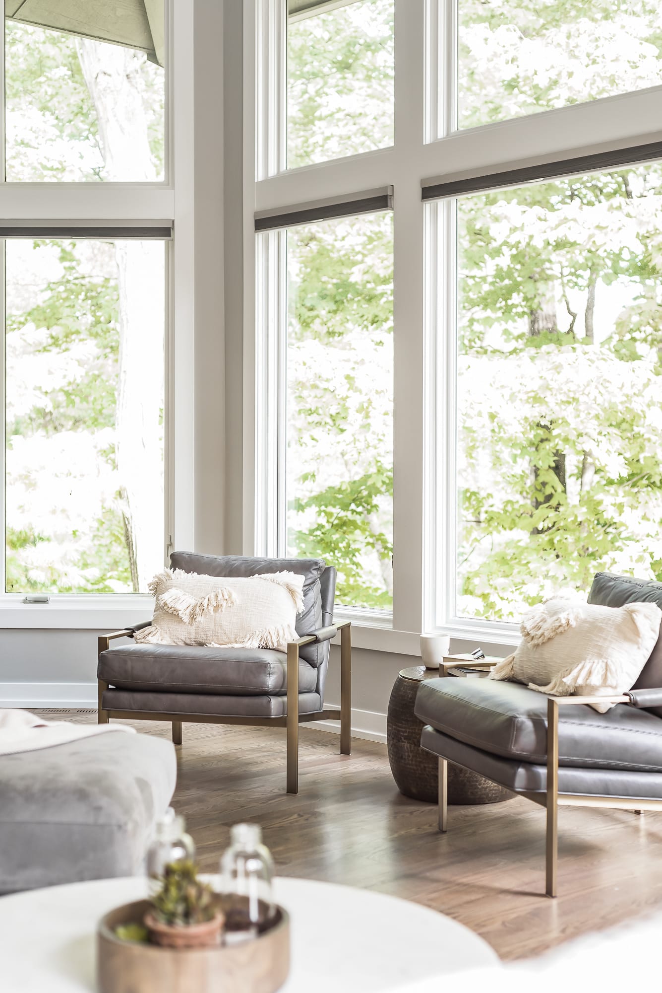 Living room remodel in Downers Grove - image of reading chairs and table, showcasing floor to ceiling windows.