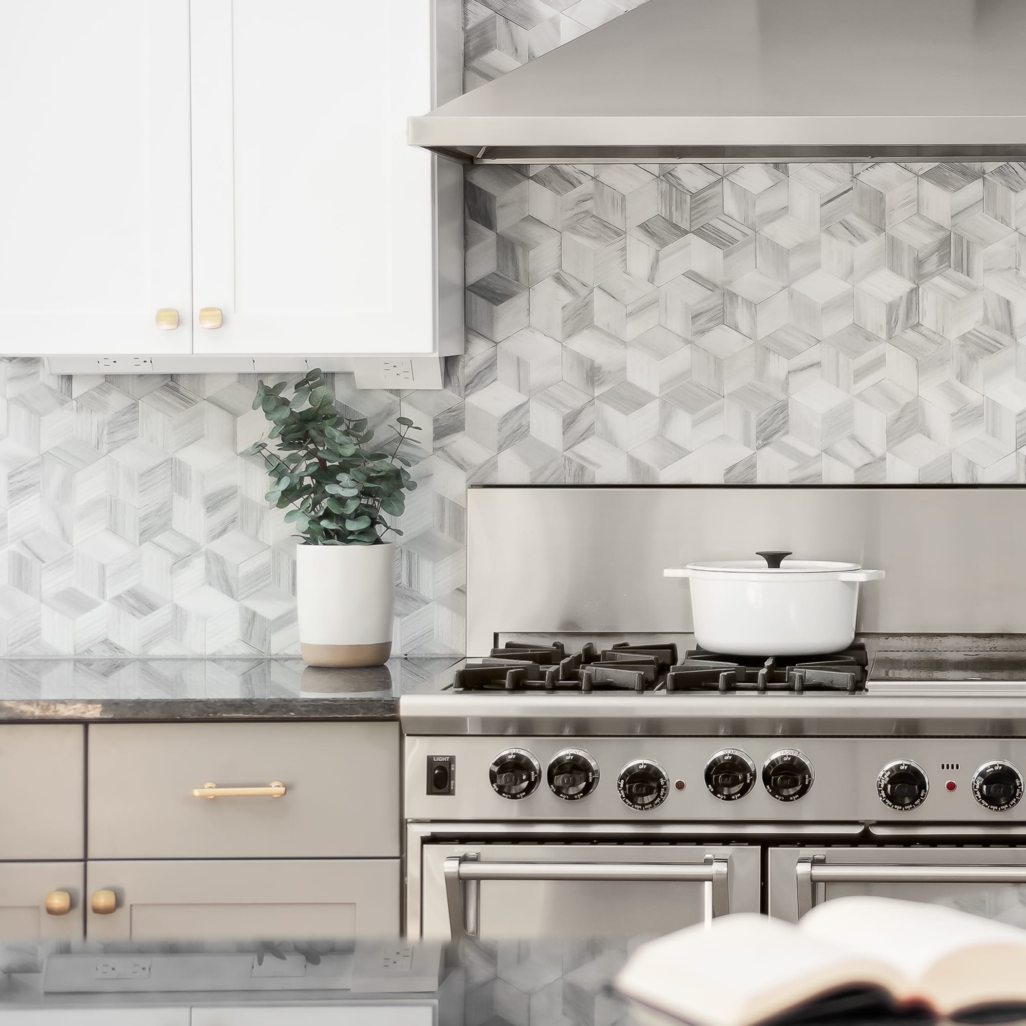 Kitchen remodel in Downers Grove - closeup view of stainless steel range and range hood, with hexagon backsplash.