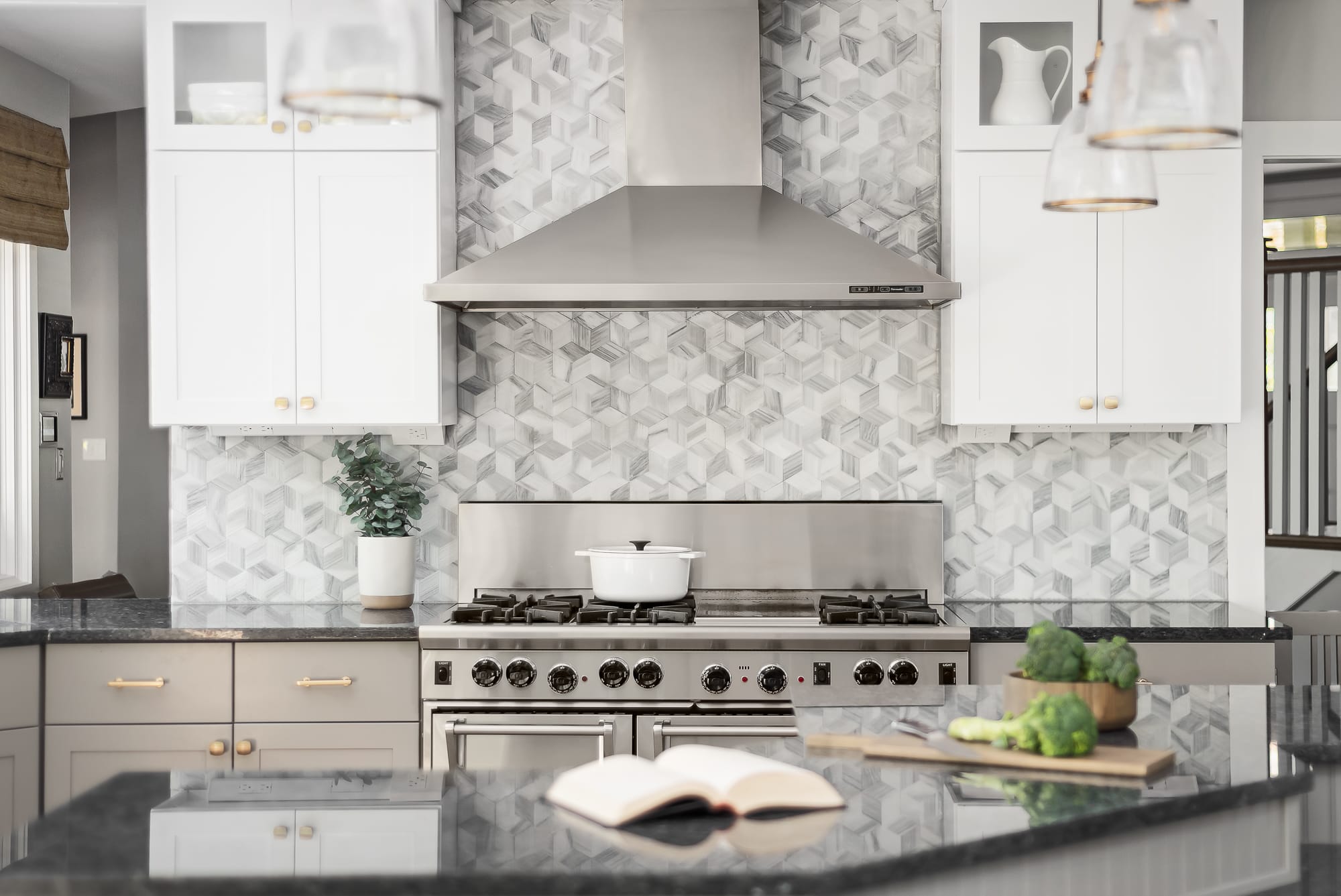 Kitchen remodel in Downers Grove - wide view of stainless steel range and range hood, with hexagon backsplash.