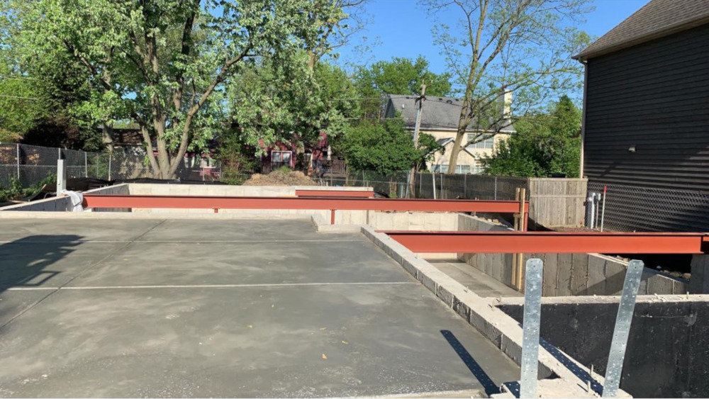 Poured foundation with some structural beams | Platinum Builders